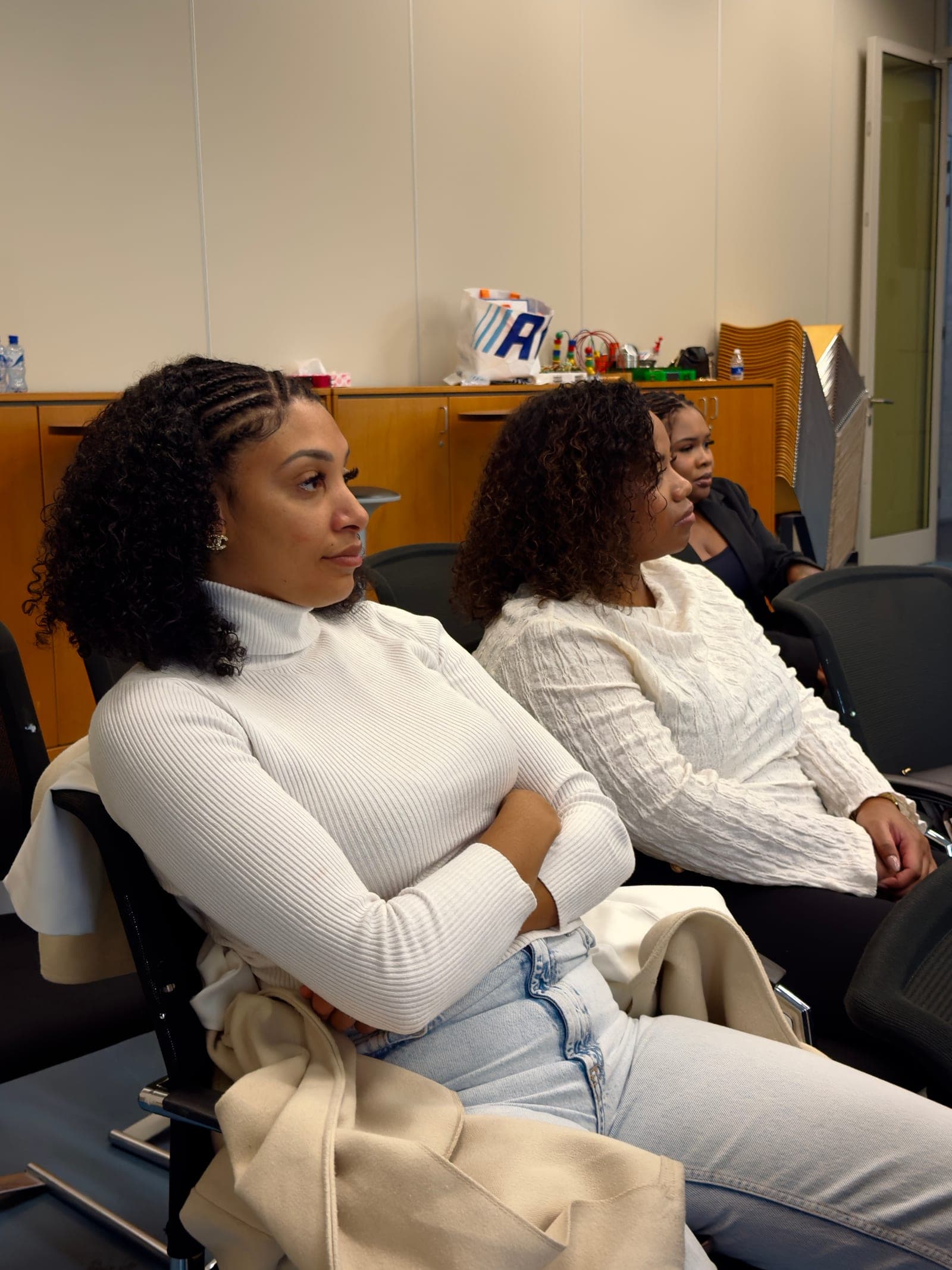 Two women in the congregation listening to the sermon