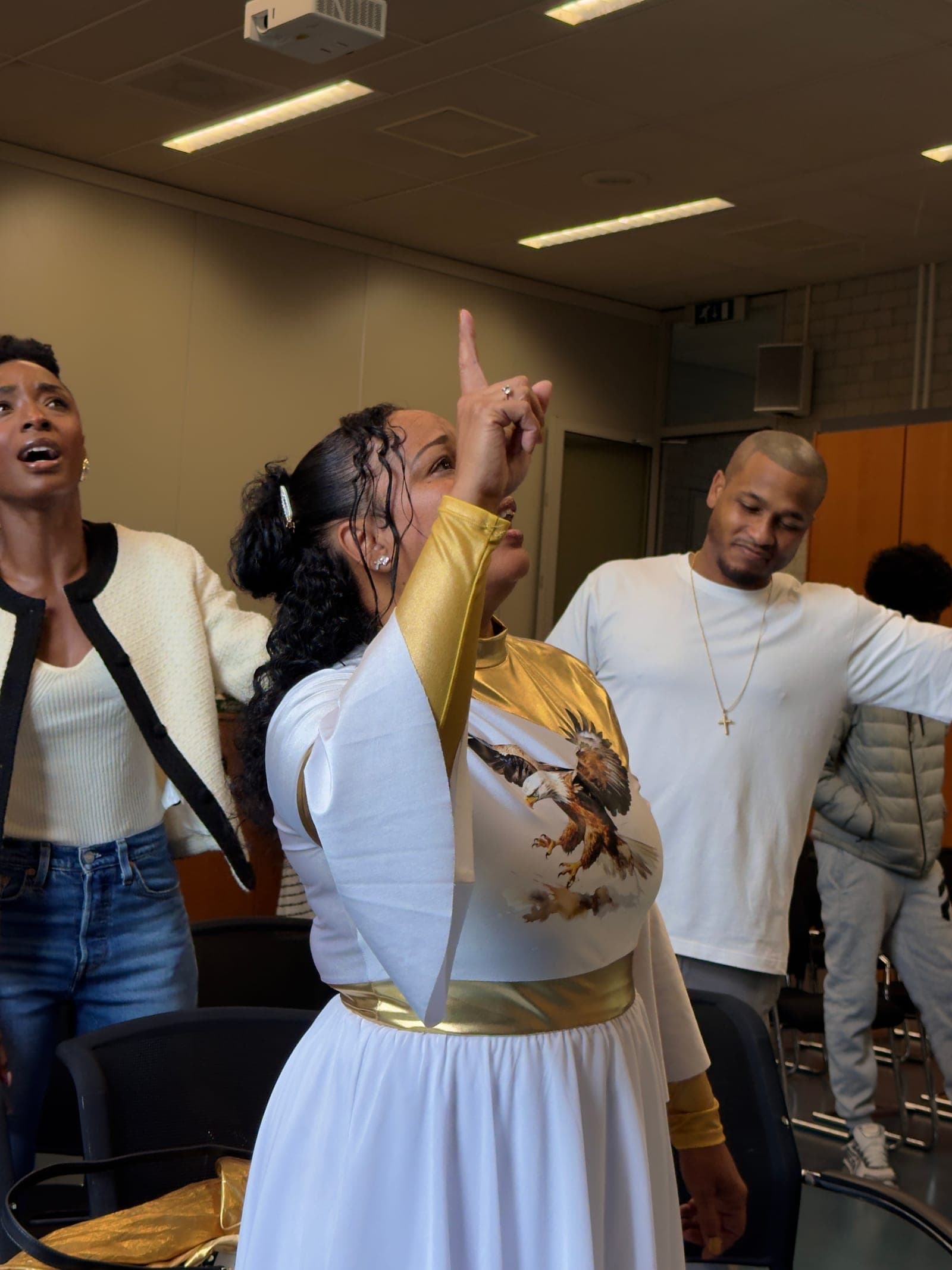 Members of the congregation worshipping with hands lifted